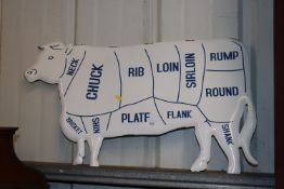 An enamel cow sign