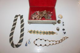 A trinket box and contents of costume jewellery
