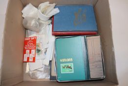 A box containing albums of stamps and various loos