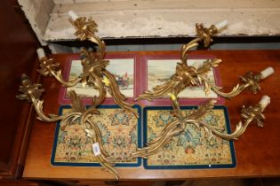 A set of four gilded Rococo style twin branch wall