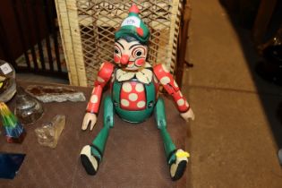 A hand painted wooden jointed Pinocchio money box