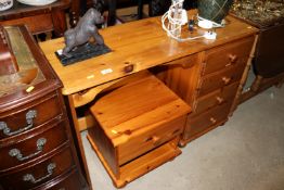 A pine single pedestal dressing table and matching