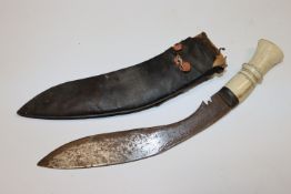 A bone handle curved dagger and scabbard