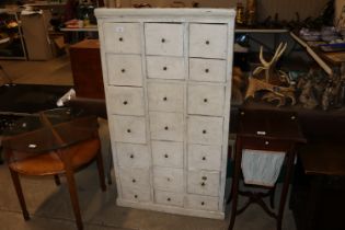 A painted multi drawer cabinet