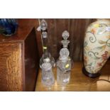 Three decanters with silver and plated tags; and a