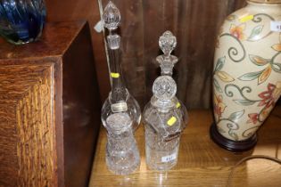 Three decanters with silver and plated tags; and a