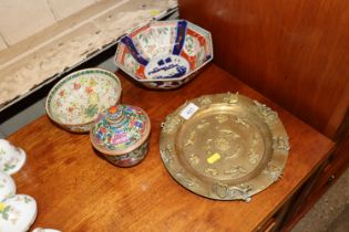 An Oriental brass plate with Imari pattern bowl an