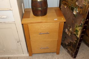 A modern light wood filing cabinet of two drawers