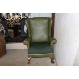 A leatherette upholstered wing back armchair raise