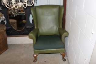 A leatherette upholstered wing back armchair raise