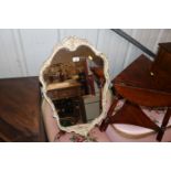 A cream and gilt wall mirror