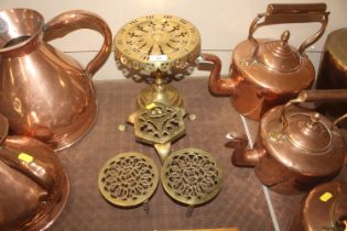 Three antique brass trivets and a large brass hear