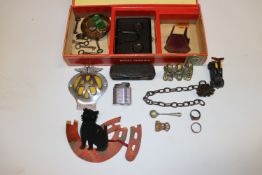 A cigar box and contents to include AA badge, bras