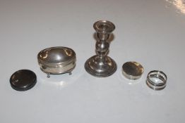 A silver candlestick with filled base; a silver tr