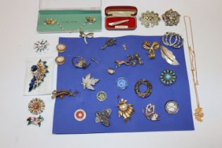 A collection of decorative costume brooches