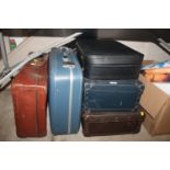 A collection of miscellaneous suitcases