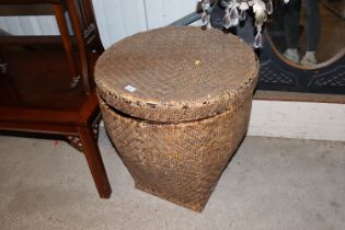 A wicker covered basket and lid