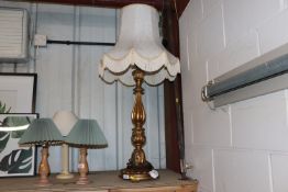 A gilt Florentine style table lamp, with white tas