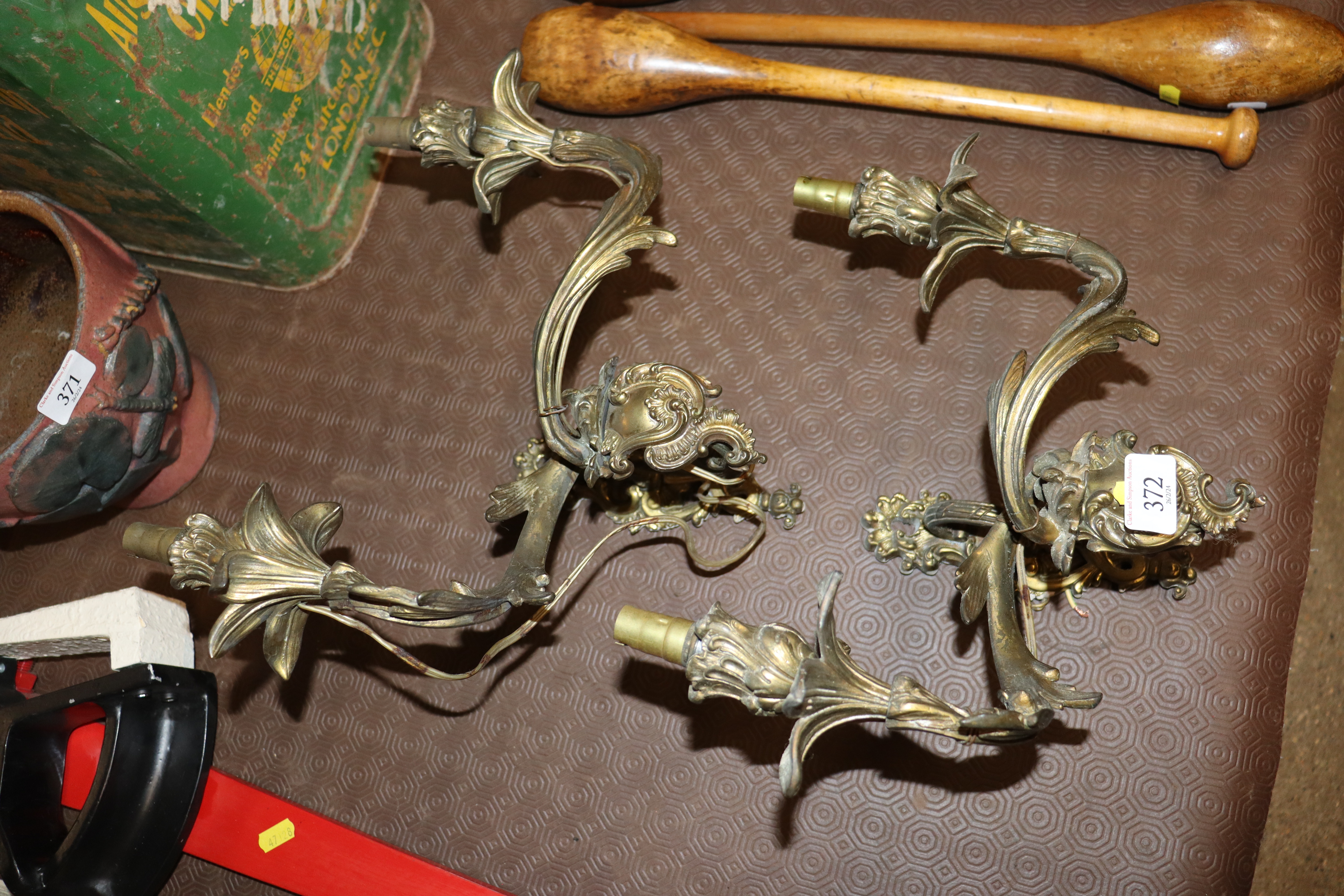 A pair of brass Rococo style twin branch wall ligh