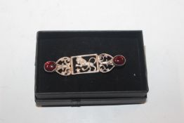 An antique silver and cabochon garnet brooch