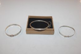 A 1958 Chester Sterling silver bangle and two othe