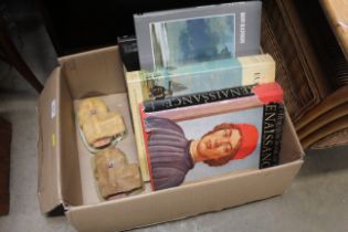 A box of art books and two cottage ornaments