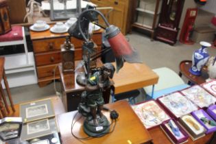 A figural decorated table lamp with mottled glass