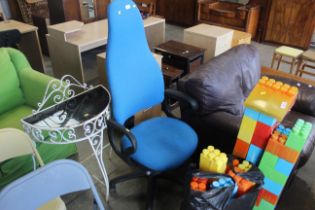 A highbacked blue upholstered office chair