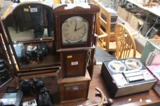 A replica grandfather clock containing Smiths cloc