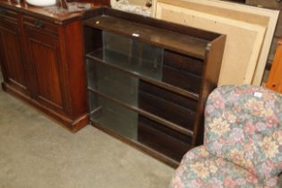 A three tier bookcase with sliding glass doors