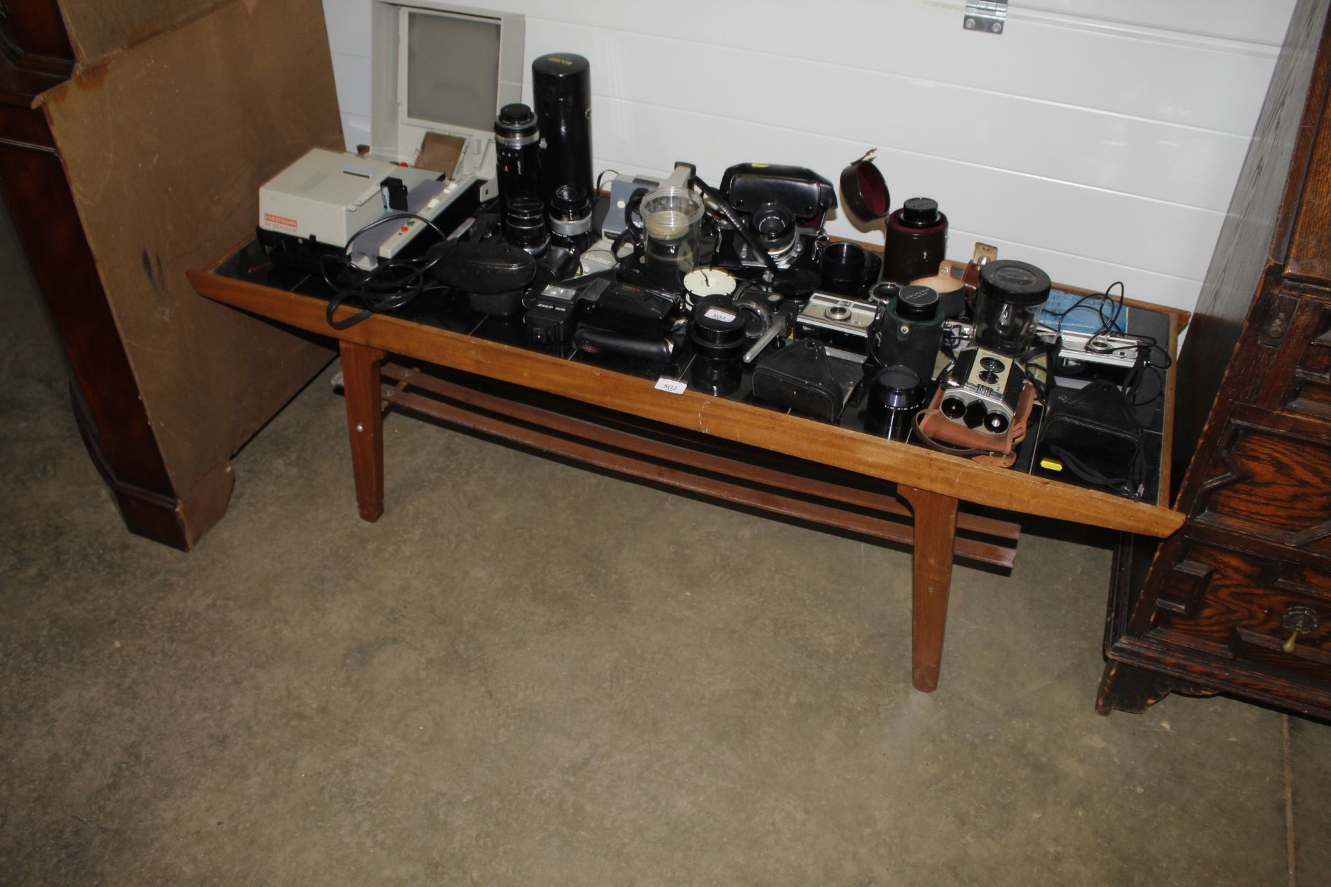 A tile topped coffee table fitted with shelf below