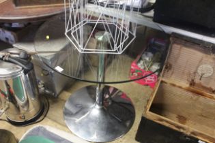 A circular glass topped table, approx. 32" dia. mo