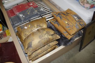 A quantity of gold coloured and floral cushions et