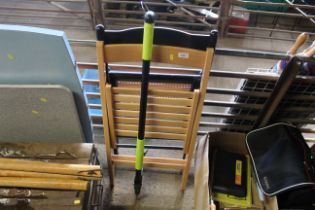 Two wooden folding chairs and a Garden Gear thistl