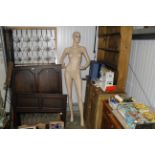 A full size female mannequin model mounted to base