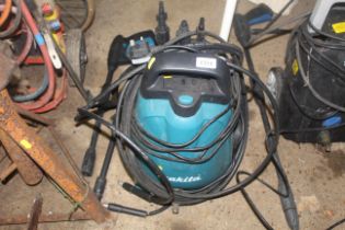 A Makita HW102 pressure washer with lance and acce