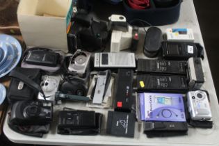 A collection of various cameras, pair of walkie ta