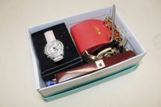 A box containing various wrist watches, desk clock