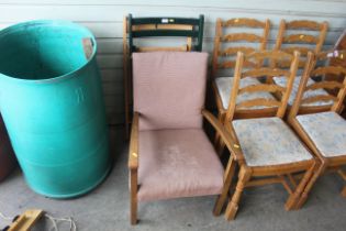 Two wooden folding chairs and an upholstered arm c