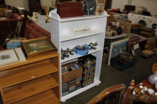 A white painted four tier bookcase
