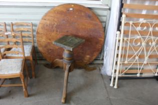 A pine circular dining table on pedestal tripod ba