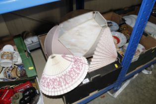 A box containing various table lampshades and thre