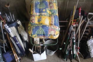 A metal framed lounge chair with cushion; a galvan