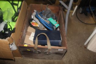 A wooden box containing various items to include p