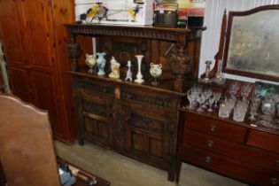 An oak court cupboard, lower section is fitted two