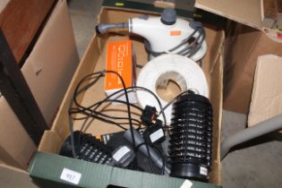 A box containing Vax steam cleaner, roll of cable,