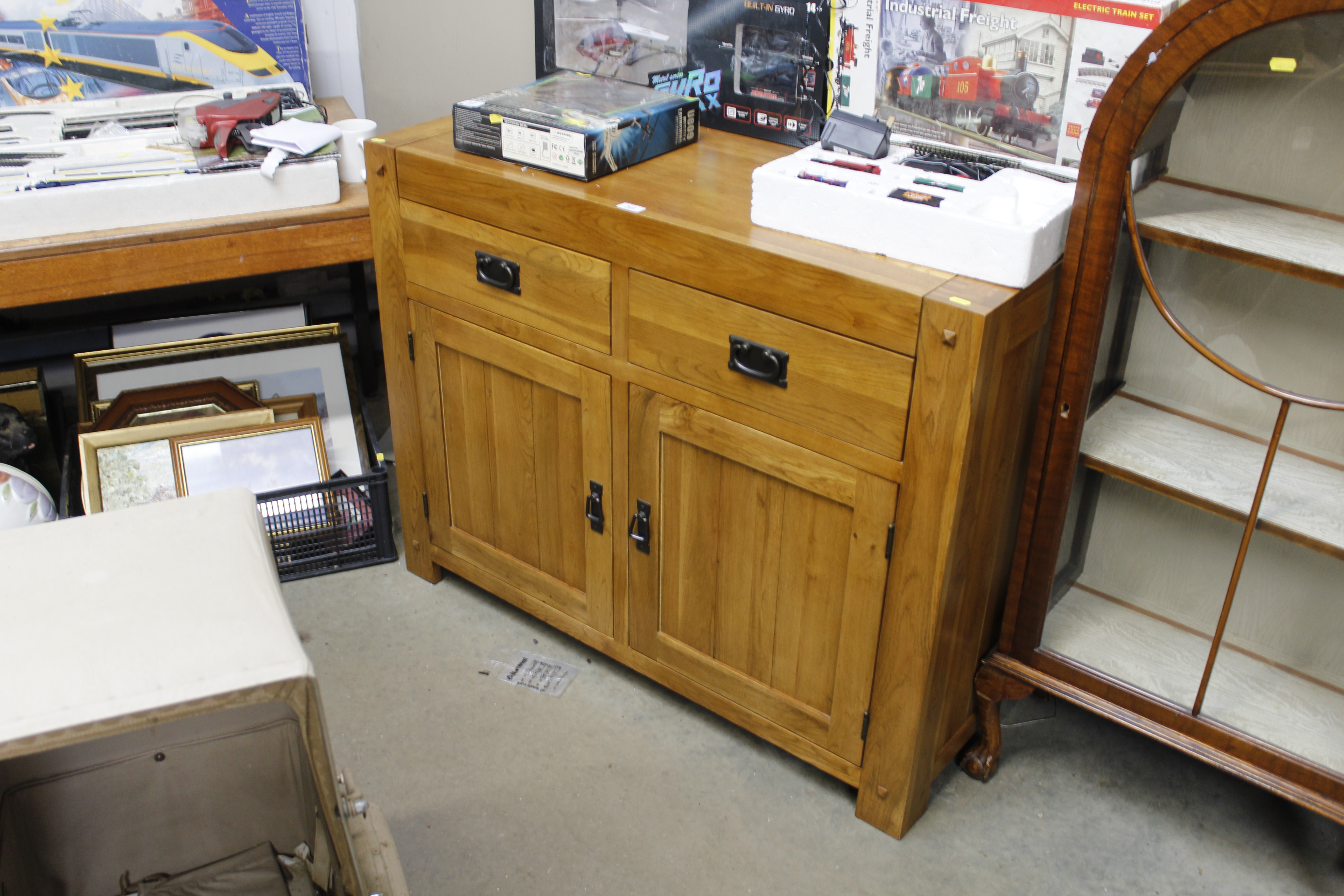 An oak sideboard fitted two short drawers over twin cupboard base