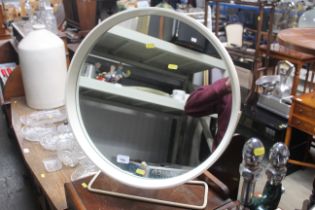 A circular dressing table mirror