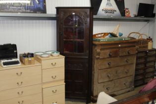 A carved and partly glazed corner cupboard