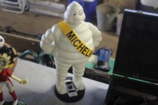 A painted cast iron statue in the form of a Michel